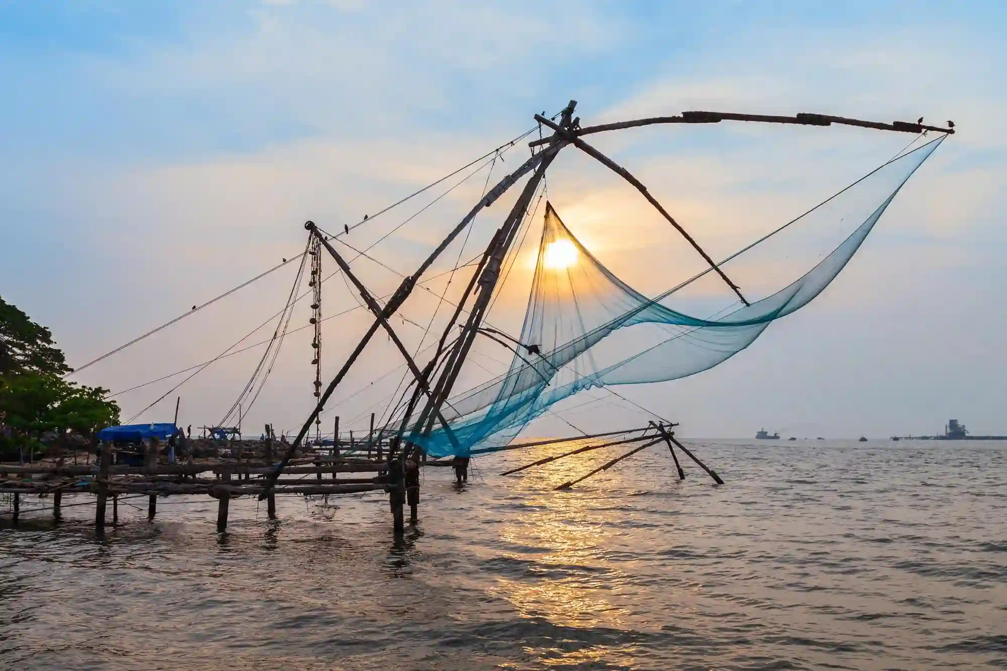 Kerala tour package sightseeing at the Chinese fishing nets in Fort Kochi at sunset