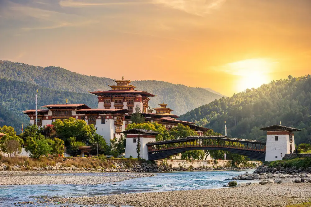Punakha Dzong and its wooden cantilever bridge at sunset in Bhutan