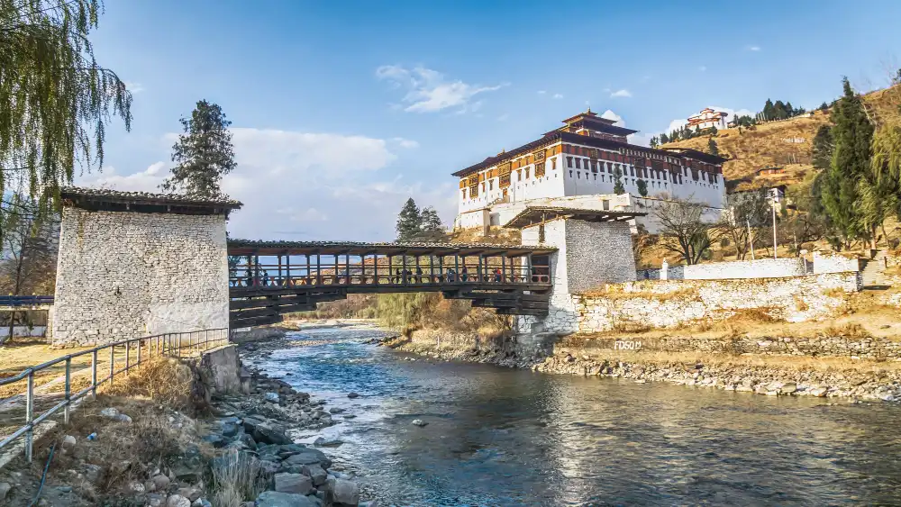 Rinpung Dzong and the covered Nyamai Zam bridge over the Paro Chhu in Paro, on the Golden Triangle of Bhutan tour with Thimphu, Punakha and Paro
