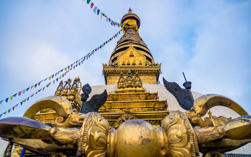 Golden spire and prayer flags at Swayambhunath Stupa in Kathmandu, Nepal